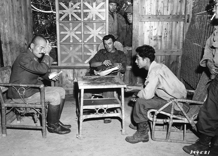 Nisei Jiro Arakaki (right) from Hawaii questions Japanese Army officer (October 1945).